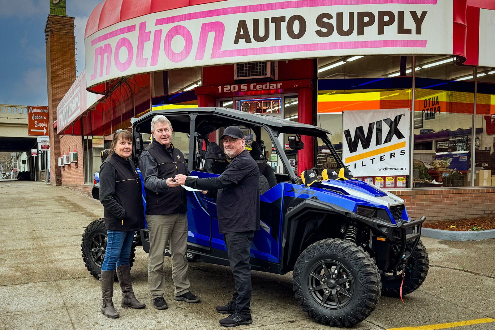 Pictured (from left to right): Pam Ledbetter (wife of winner), Dave Ledbetter (grand prize winner), James Hutton (delivery)